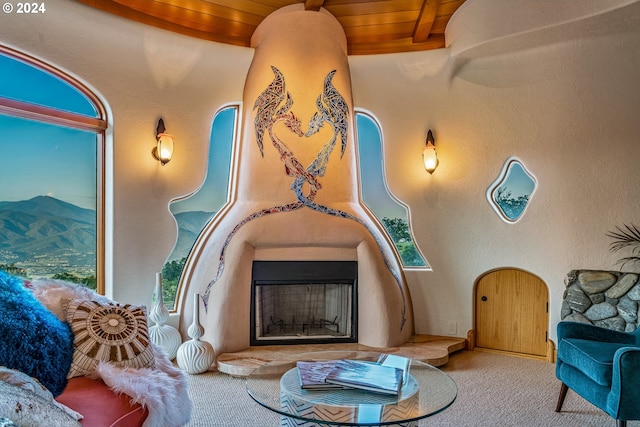 interior space featuring wooden ceiling, beamed ceiling, and carpet