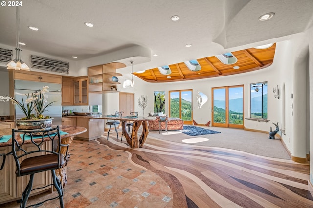 dining space with beam ceiling, wood ceiling, and high vaulted ceiling