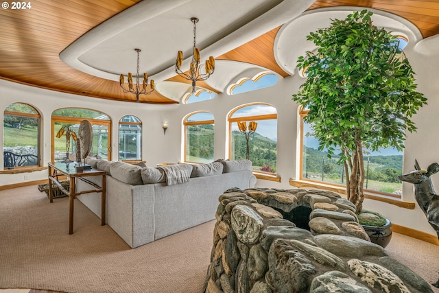 carpeted living room with an inviting chandelier