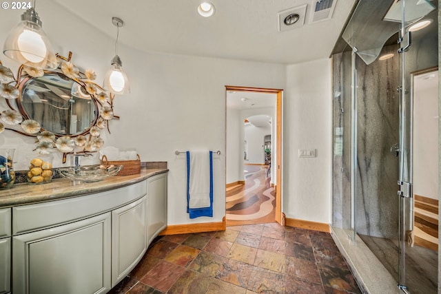 bathroom featuring vanity and an enclosed shower