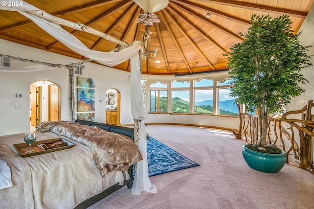 bedroom with a mountain view, wooden ceiling, and carpet