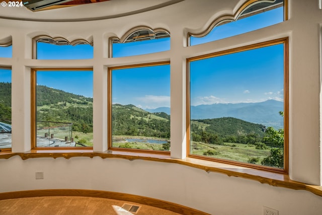 unfurnished sunroom with a mountain view