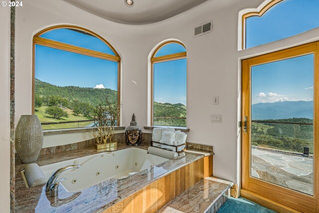 bathroom with a relaxing tiled tub