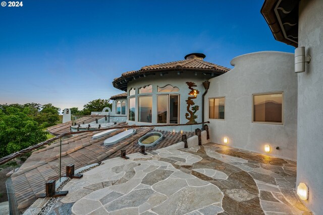 view of patio terrace at dusk