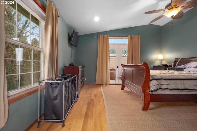 bedroom featuring multiple windows, ceiling fan, light hardwood / wood-style flooring, and lofted ceiling