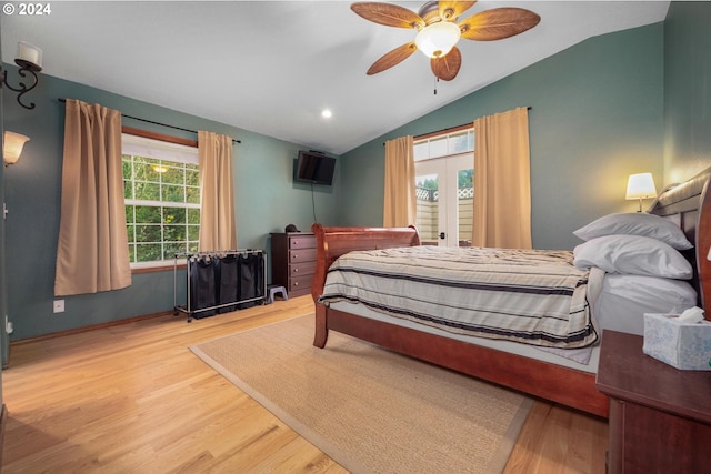 bedroom with ceiling fan, wood-type flooring, and lofted ceiling