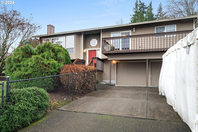 view of front of property with a balcony and a garage