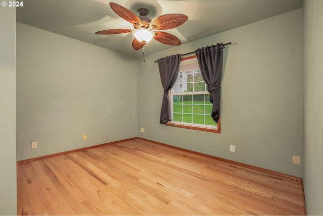 unfurnished room featuring light hardwood / wood-style flooring and ceiling fan