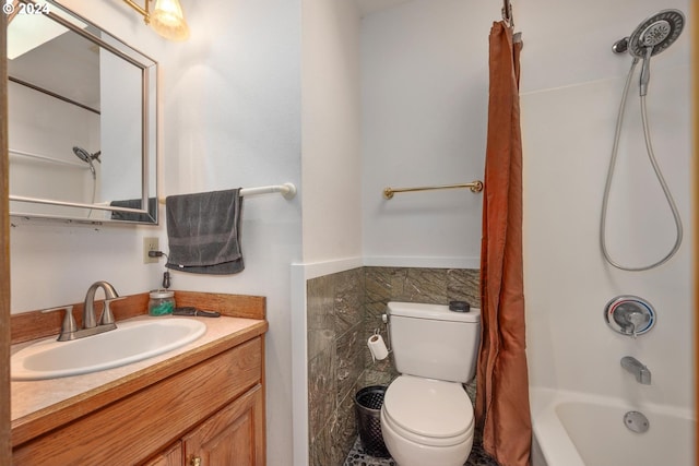 full bathroom featuring vanity, toilet, shower / bathtub combination with curtain, and tile walls