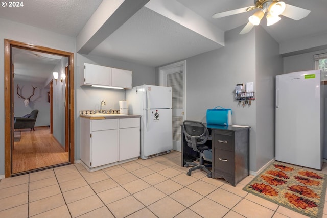 kitchen featuring white cabinetry, ceiling fan, a textured ceiling, and white refrigerator