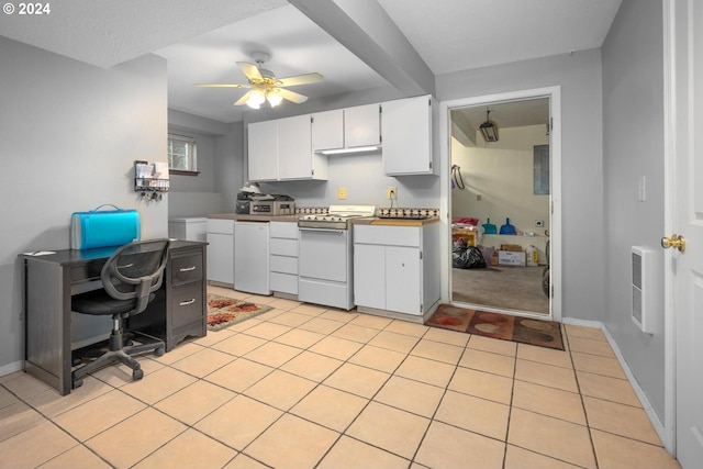 kitchen featuring white stove, ceiling fan, light tile patterned floors, white cabinetry, and heating unit