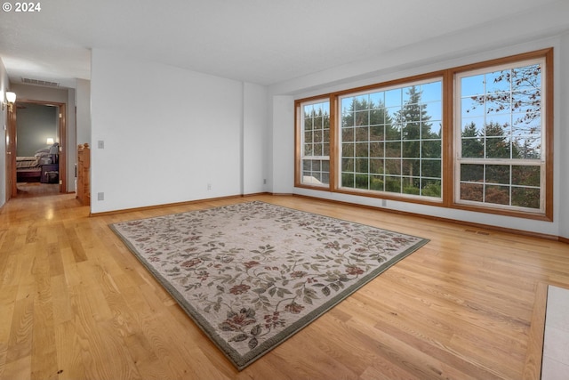 empty room with light hardwood / wood-style floors