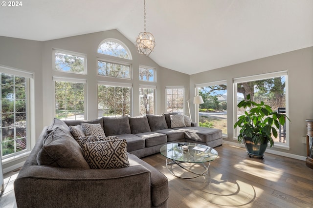 sunroom featuring a notable chandelier and vaulted ceiling