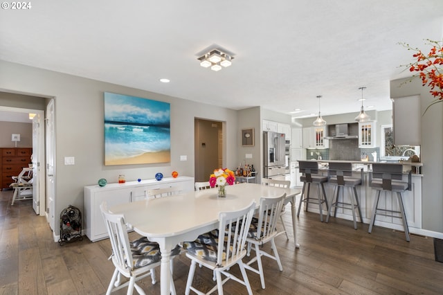 dining room featuring recessed lighting, baseboards, and dark wood finished floors