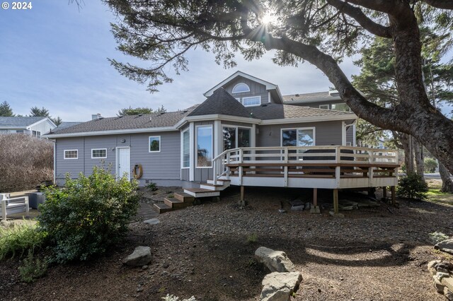 back of house featuring a deck and a yard