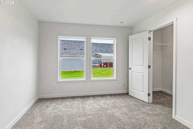 unfurnished bedroom featuring ornamental molding, light colored carpet, a closet, and multiple windows