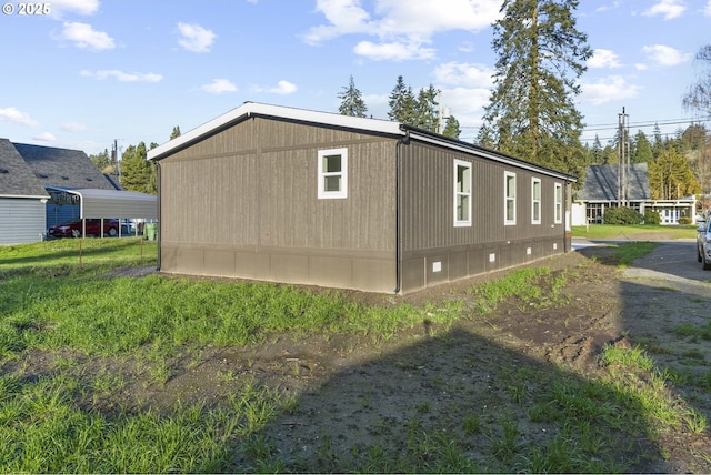 view of side of home with a carport