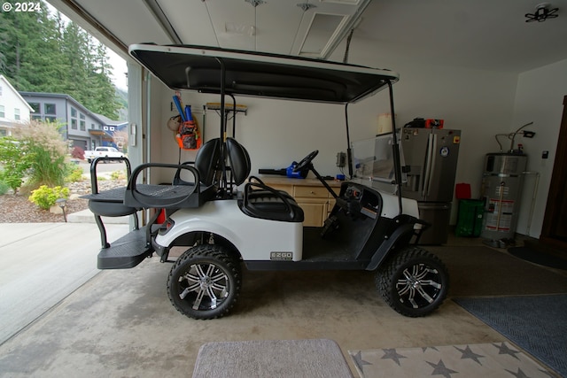 garage featuring stainless steel fridge and water heater