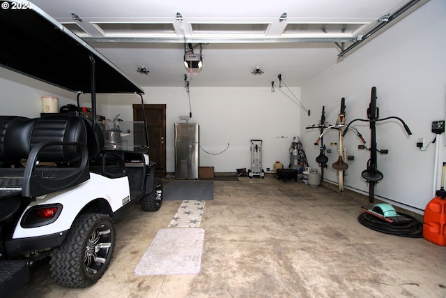 garage featuring a garage door opener and stainless steel fridge