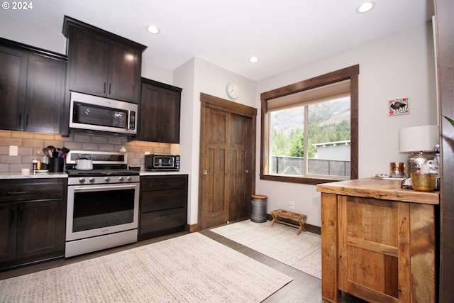 kitchen featuring dark brown cabinets, appliances with stainless steel finishes, and decorative backsplash