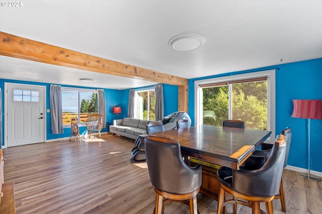 dining room featuring beamed ceiling and hardwood / wood-style floors