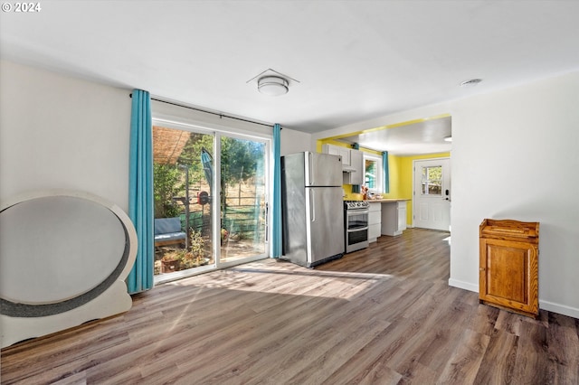 interior space featuring hardwood / wood-style flooring and a healthy amount of sunlight