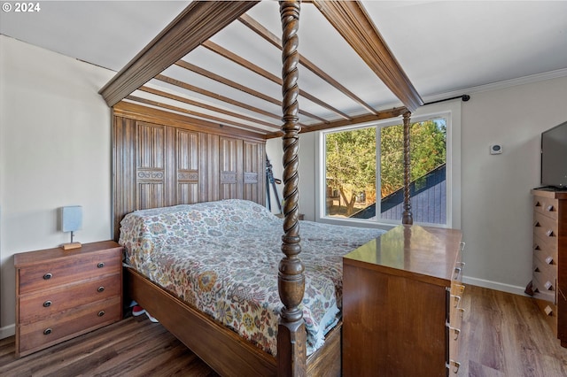 bedroom with crown molding and dark hardwood / wood-style flooring