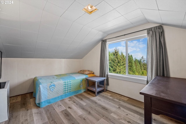 bedroom with lofted ceiling and light hardwood / wood-style floors