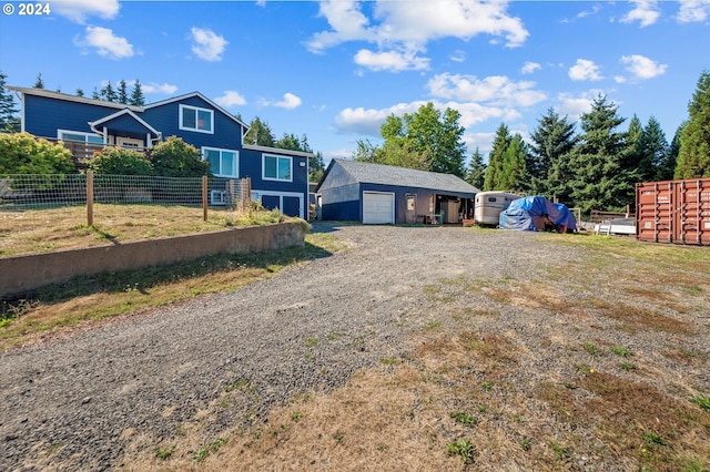 view of yard with a garage and an outbuilding