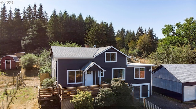 view of front of property featuring a shed