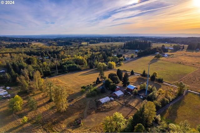 aerial view at dusk featuring a rural view