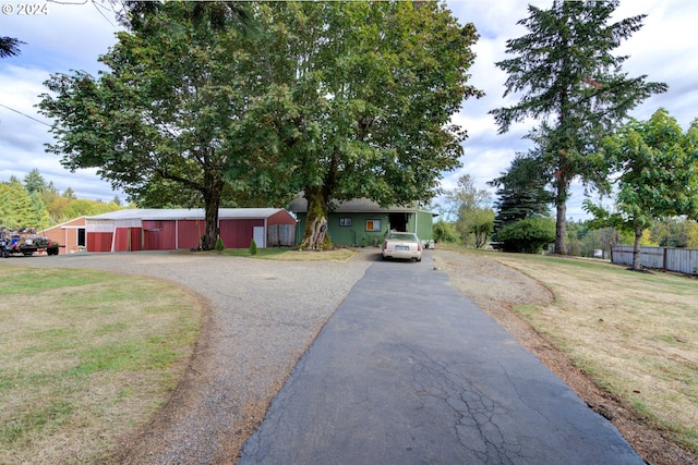 view of front of property with a front yard and an outdoor structure