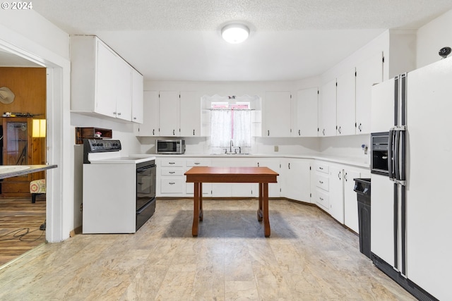 kitchen with a textured ceiling, sink, white cabinets, light hardwood / wood-style flooring, and white appliances