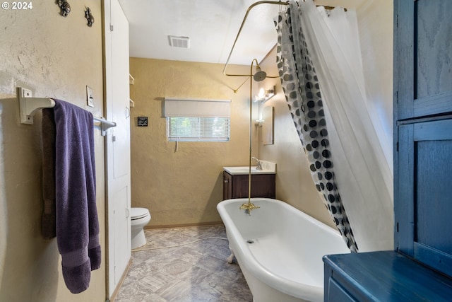 bathroom featuring a bath, vanity, and toilet