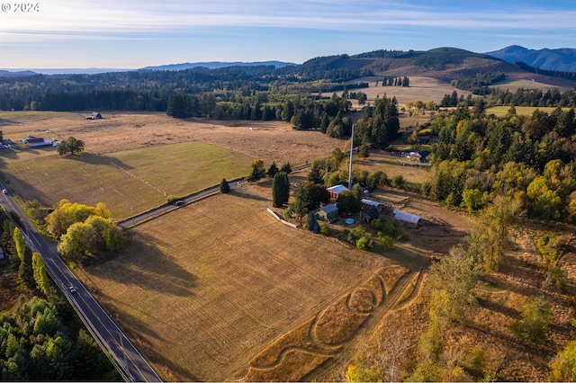 drone / aerial view featuring a rural view and a mountain view