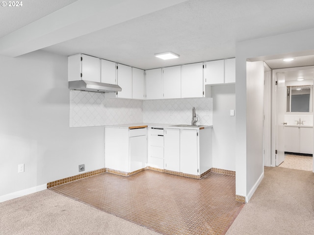 kitchen with backsplash, sink, white cabinets, and exhaust hood