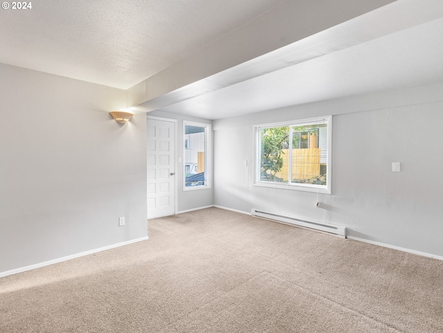 empty room featuring a textured ceiling, carpet floors, and a baseboard radiator