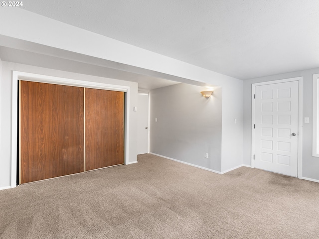 unfurnished bedroom with carpet and a closet