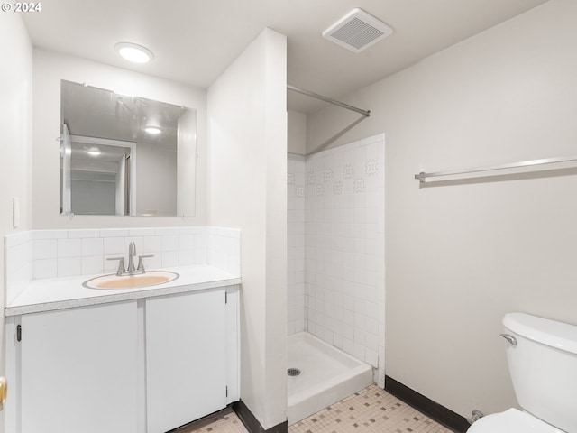 bathroom with a shower, vanity, toilet, and tile patterned flooring