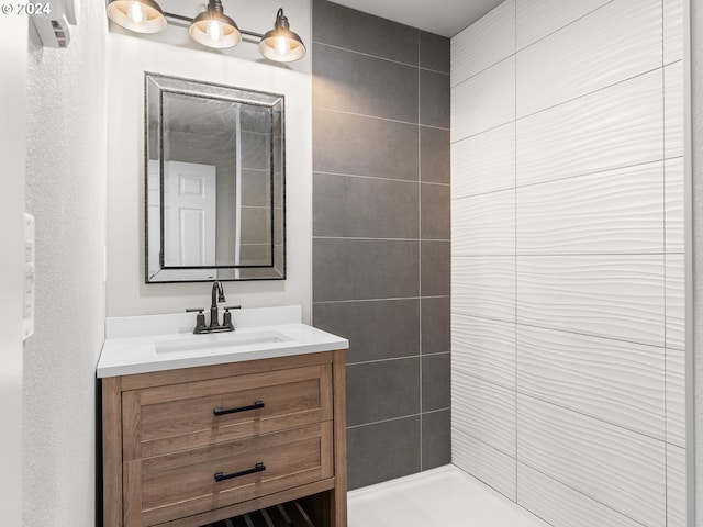 bathroom featuring vanity and tiled shower