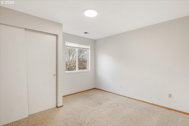 unfurnished bedroom with a closet and carpet floors