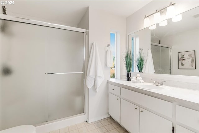 bathroom with vanity and a shower with shower door