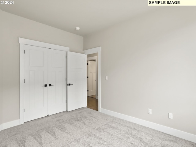 unfurnished bedroom featuring carpet and a closet