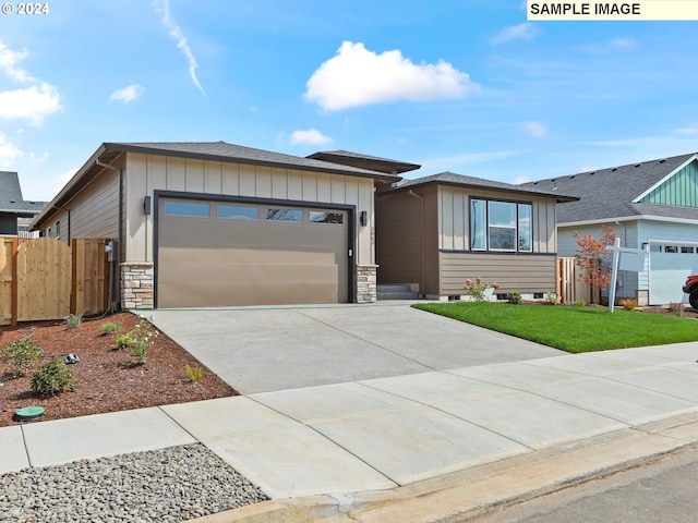 view of front of home featuring a front lawn and a garage