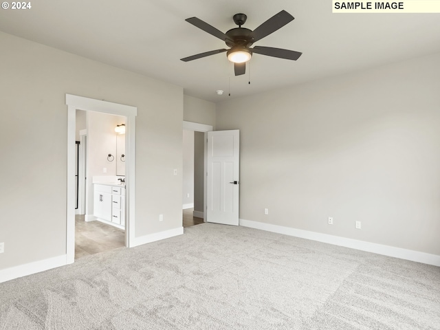 unfurnished bedroom with light colored carpet, ceiling fan, and ensuite bathroom