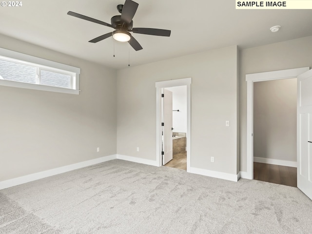 unfurnished bedroom featuring ceiling fan, light colored carpet, and connected bathroom