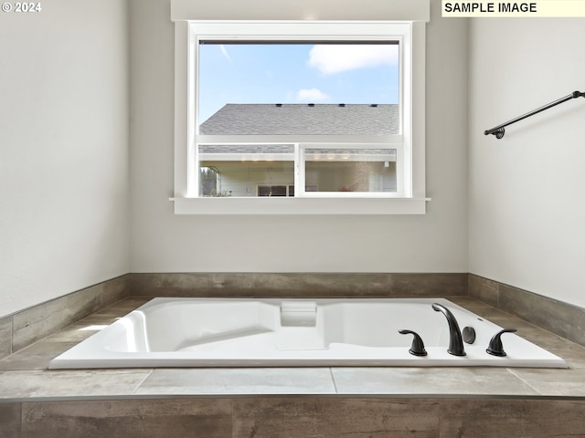 bathroom with tiled tub