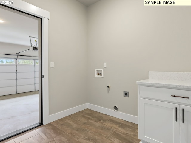 laundry room featuring hookup for an electric dryer, cabinets, and hookup for a washing machine