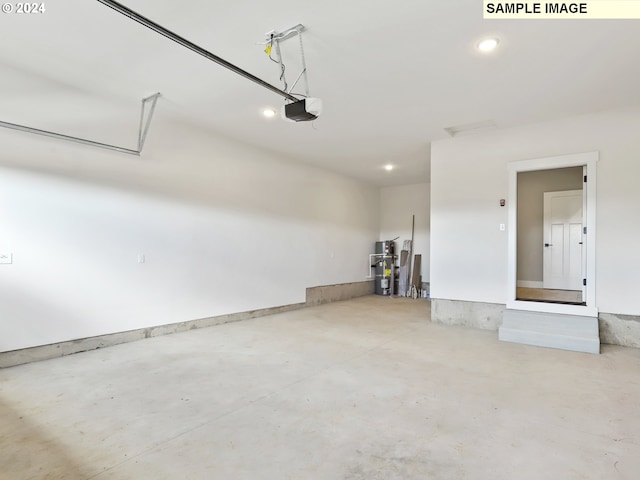 garage featuring secured water heater and a garage door opener