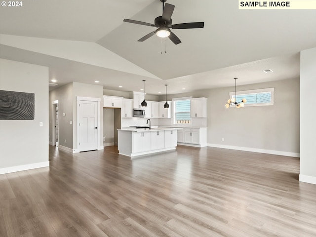 unfurnished living room with plenty of natural light, lofted ceiling, and light hardwood / wood-style flooring